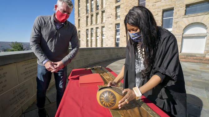 Tamar Evangelestia-Dougherty, associate university librarian, right, examines a bowl presented by Mohegan Tribal Historic Preservation Officer James Quinn in a ceremony at Cornell University transferring the Fidelia Fielding’s diaries.